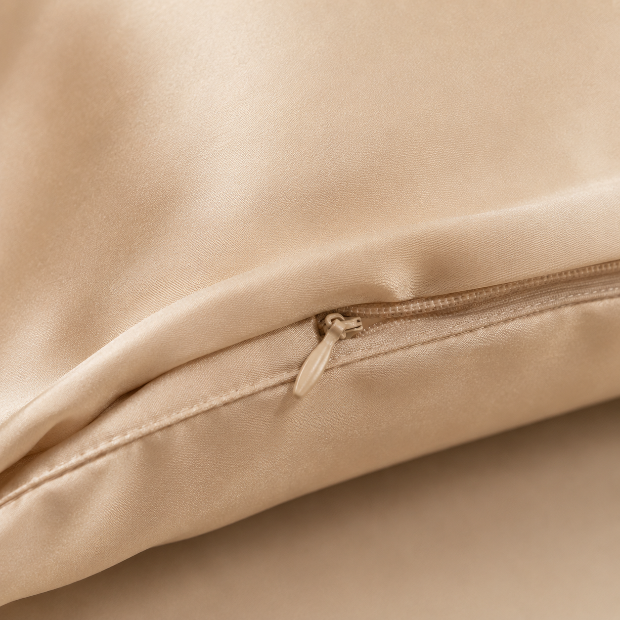 Hidden zipper closure detail on the champagne silk pillowcase